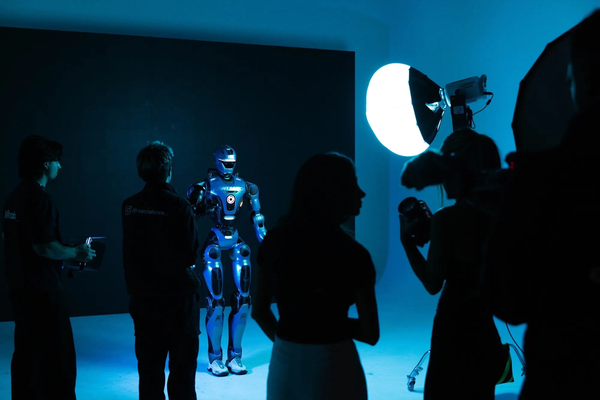 MIGHTY MECH under blue studio light, surrounded by the photo crew at an HFC shoot